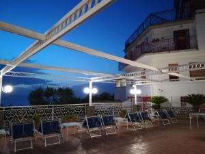 a group of chairs and tables on a patio at Hotel Dania in Sorrento