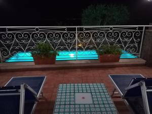 a balcony with blue lights on a fence at Hotel Dania in Sorrento