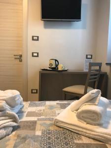 a hotel room with a bed with towels on it at Antiche Terre Hotel & Relax in Pignone