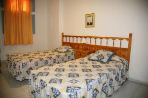 Postel nebo postele na pokoji v ubytování Apartamentos San Sebastián