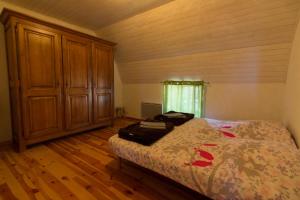 a bedroom with a bed and a wooden floor at Village de Nasbinals Aubrac Electro Vélo in Nasbinals +7 photos