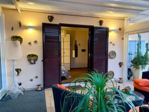 a living room with an open door with a plant at Sunset Terrazza in Reggio di Calabria