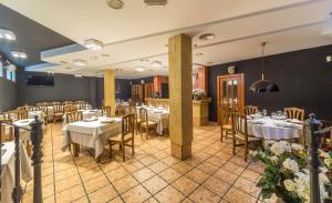 a restaurant with tables and chairs in a room at LA POSADA DE HIGUERUELA in Higueruela +21 photos