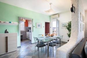 a kitchen and dining room with a table and chairs at Horizont view apartment in Pula