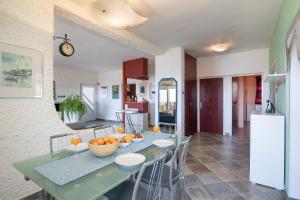 a dining room and kitchen with a table and chairs at Horizont view apartment in Pula