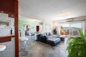 a living room with a couch and a table at Horizont view apartment in Pula