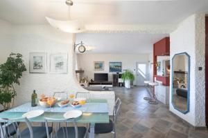 a dining room and living room with a table and chairs at Horizont view apartment in Pula