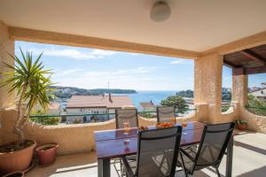 a patio with a table and a view of the ocean at Horizont view apartment in Pula