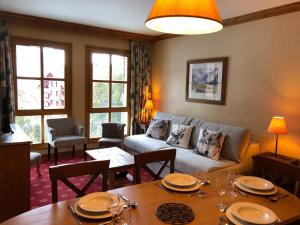 a living room with a couch and a table at Le Refuge du Montagnard, Arc 1950, Skis aux pieds, Spa in Arc 1950 +19 photos