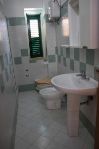 a bathroom with a sink and a toilet at Baia di Zambrone in Zambrone