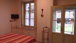 Postel nebo postele na pokoji v ubytování Agriturismo Cascina Poscallone