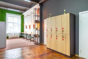 a room with lockers and a room with a table at Hostel 5Nebo in Moscow