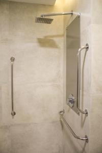 a shower with a glass door in a bathroom at Slaviero Campina Grande in Campina Grande