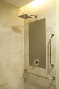 a bathroom with a shower with a mirror on the wall at Slaviero Campina Grande in Campina Grande