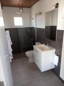 a bathroom with a white sink and a toilet at Ático Los Lomos in El Paso