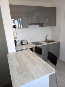 a kitchen with a table and chairs and a sink at Ático Los Lomos in El Paso