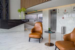a lobby with a chair and a table at Slaviero Campina Grande in Campina Grande