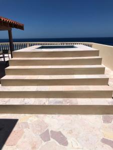 a set of stairs with the ocean in the background at The Meridian at Lighthouse Point in West Bay