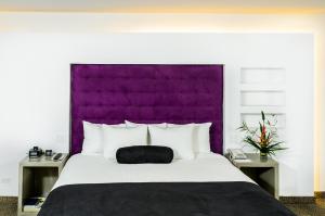 Ein Bett oder Betten in einem Zimmer der Unterkunft Riande Aeropuerto Hotel Casino