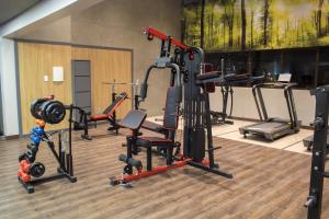 a gym with several different types of equipment in a room at Slaviero Campina Grande in Campina Grande
