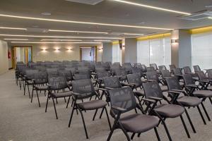 a room with rows of chairs in a hall at Slaviero Campina Grande in Campina Grande