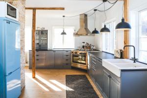 a kitchen with stainless steel appliances and a blue refrigerator at Hoepfner and Tulinius Historical Houses in Akureyri