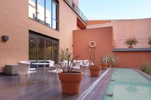 
a patio area with a patio table and chairs at Exe Tres Cantos in Tres Cantos
