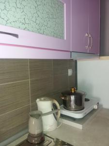 a kitchen with purple cabinets and a pot on a stove at Villa Marili in Paralia Katerinis +48 photos