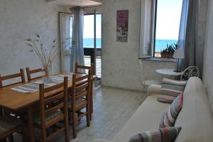 a living room with a table and a couch at Casa Vacanza Sweet Home in Giardini Naxos