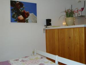 a bedroom with a bed and a cabinet and a picture on the wall at Apartments K & K Dubrovnik in Dubrovnik