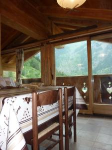 a dining room with a table and some windows at La Cincia in Morgex