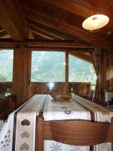 a bed in a room with a large window at La Cincia in Morgex