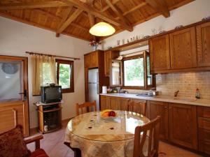 a kitchen with a table in the middle of it at Anania Cottage in Skopelos Town