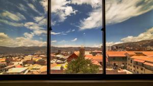 a view of a city from a window at Hotel Coloso Potosi in Potosí