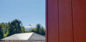 a view of a snow covered mountain from a building at Cabañas Jael in Licán Ray