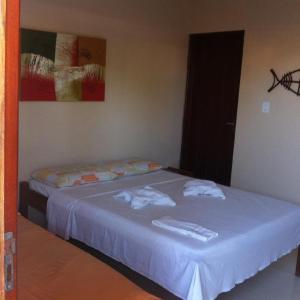 En eller flere senge i et værelse på Pousada Sua Casa