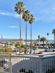 a view of a parking lot with palm trees at Seaway Inn in Santa Cruz