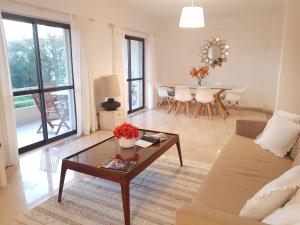 a living room with a couch and a table at Ocean Cascais - Apartment with Swimming Pool in Cascais