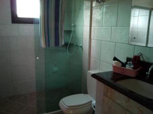 a bathroom with a toilet and a sink and a shower at Casa Baia da Babitonga in São Francisco do Sul +28 photos