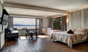 a bedroom with a bed and a table with a view at Las Liebres in San Carlos de Bariloche
