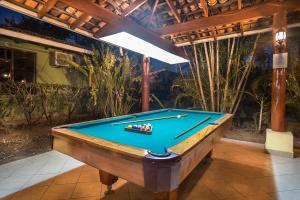 a pool table sitting on a patio with awning at Hotel Boutique Bahia Esmeralda in Potrero