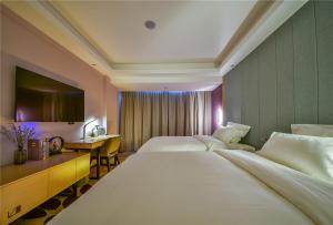 Ένα ή περισσότερα κρεβάτια σε δωμάτιο στο Lavande Hotel Dali Erhai Park Branch