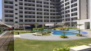 ein großes Apartmenthaus mit einem Innenhof und einem Pool in der Unterkunft 1BR Grace Residences w/ Internet- near BGC/McKinley in Manila