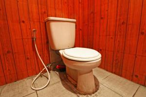 a bathroom with a toilet with a hose at Wiens Residence BSD in Tangerang