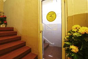 a door with a sign on it next to some stairs at Wiens Residence BSD in Tangerang