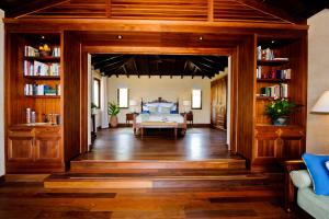a bedroom with a bed in a room with bookshelves at Royal Isabela in Isabela