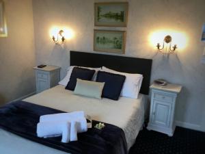 a bedroom with a large bed with two night stands at Royal Mail Hotel in Lumsden