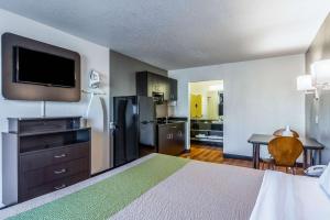a hotel room with a bed and a kitchen at Studio 6-Little Rock, AR - West in Little Rock