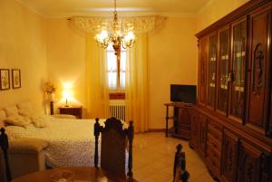 a bedroom with a bed and a chandelier at Casa S.Maria in Levane