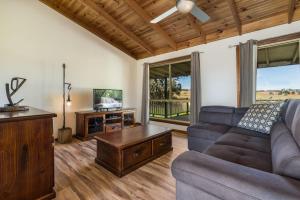 a living room with a couch and a tv at Reflections Grabine Lakeside - Holiday Park in Bigga